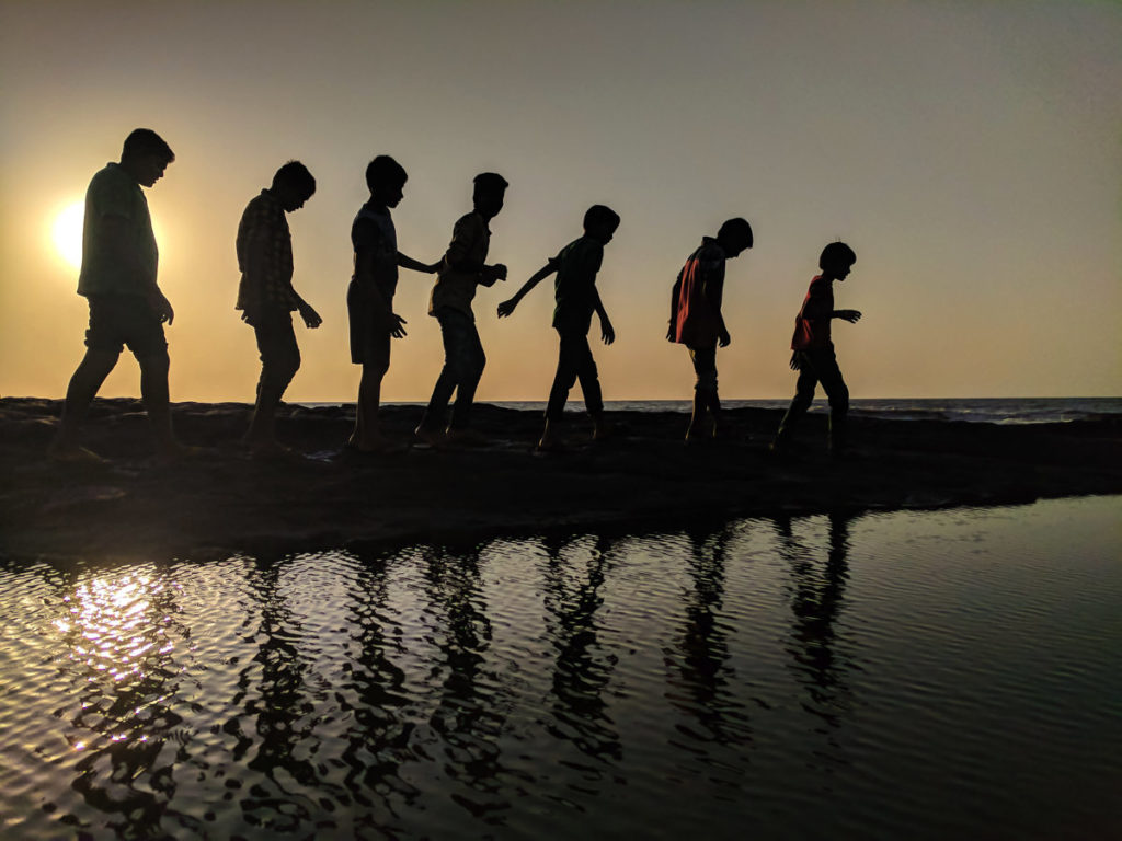 kids bonding while walking along the water