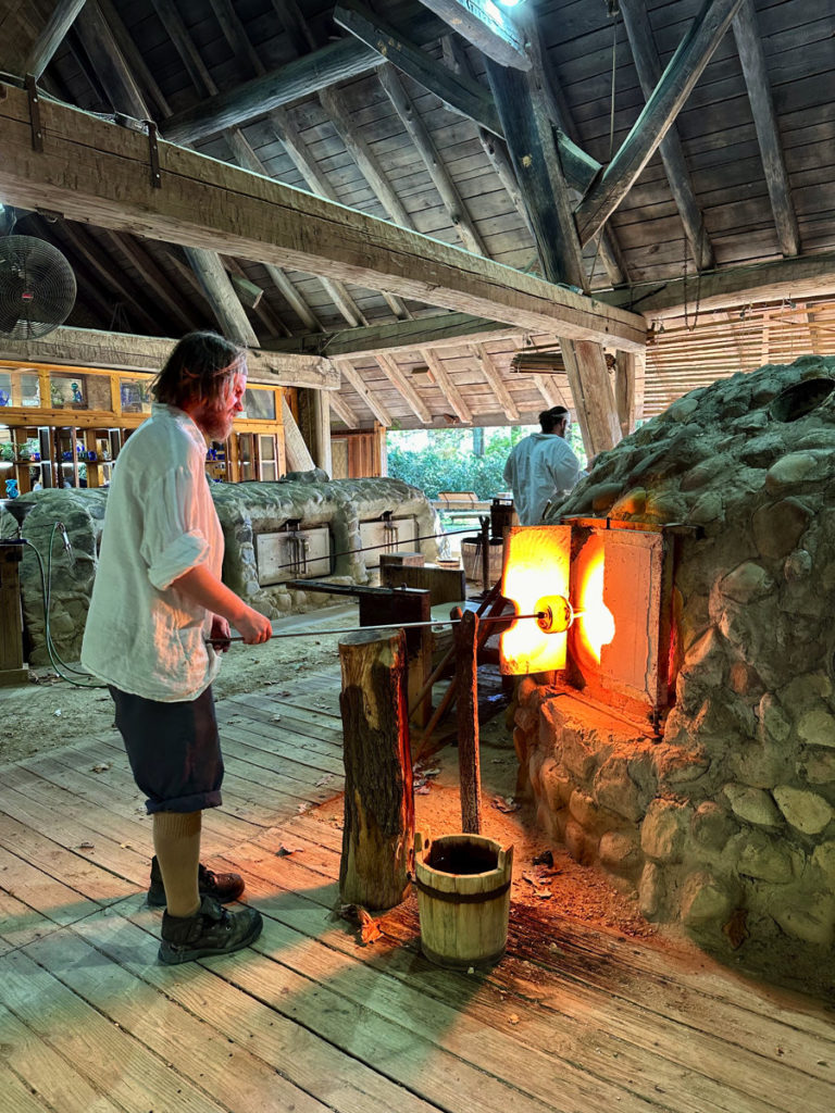 Glassblowers making glass at Jamestown Glasshouse